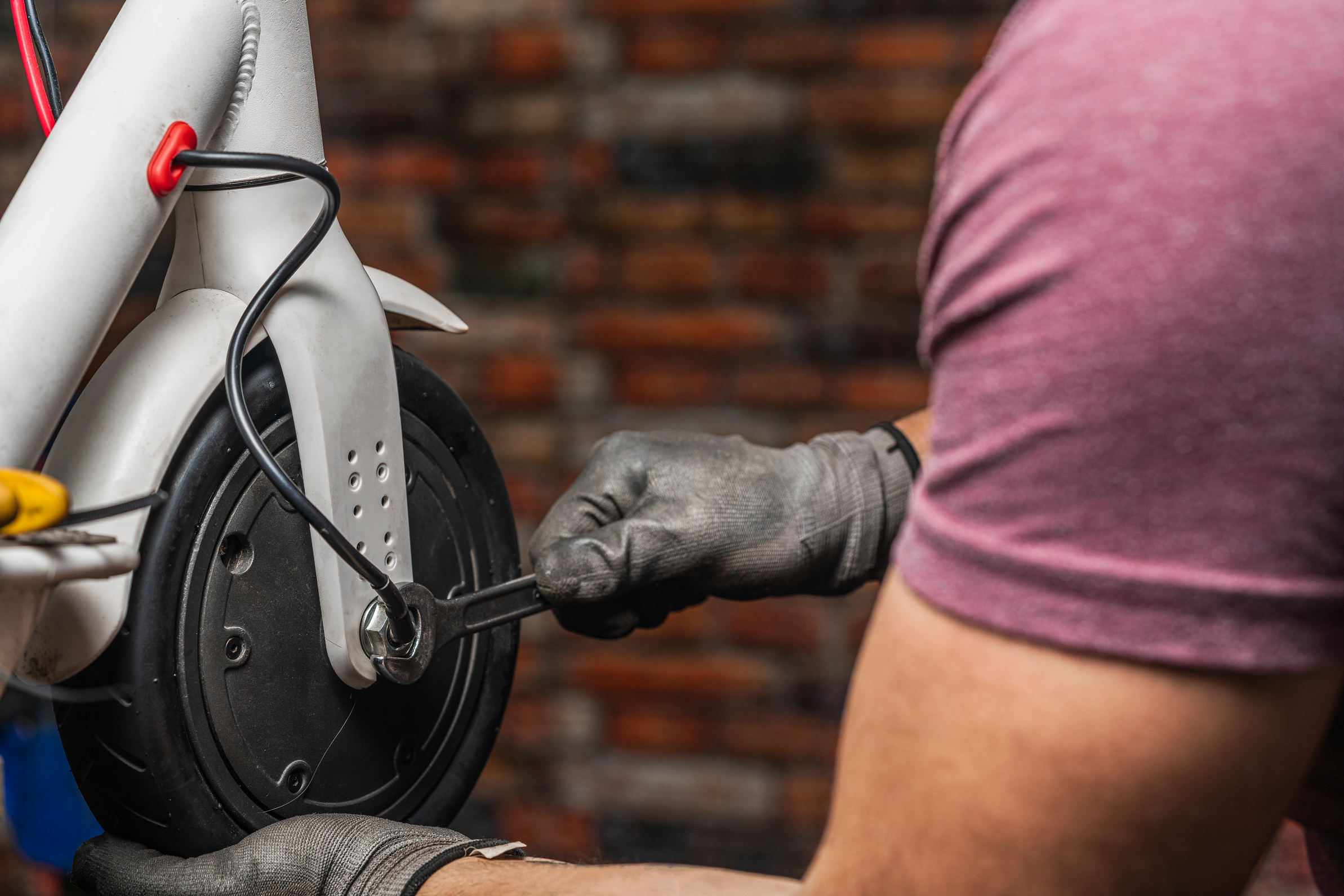 An unrecognizable mechanic holding and adjusting the electri